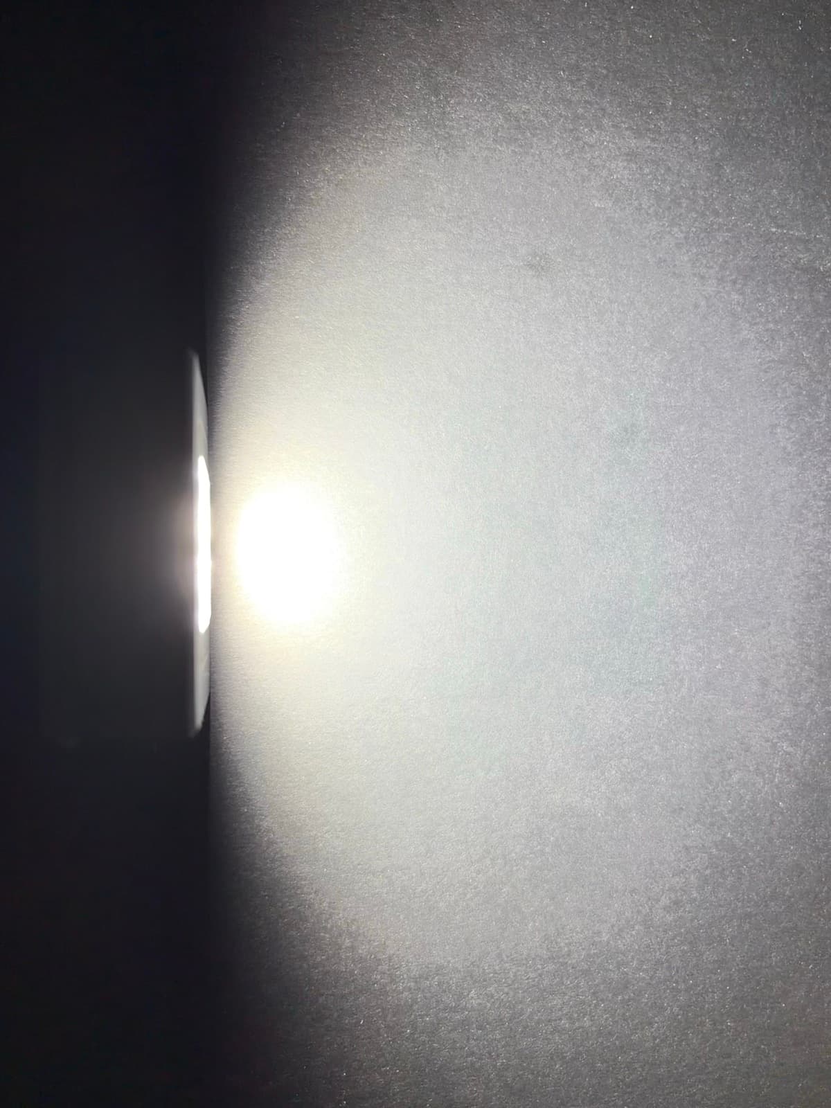 Maglight M1 beam visualized against a wall in a dark room